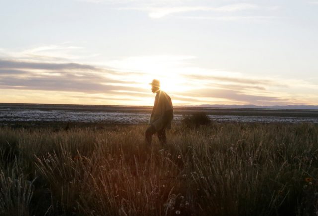 An Urus Muratos man walks on the shores of the dried lake Poopo affected by climate change, in the Oruro Department